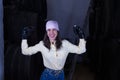 Portrait of young and fighter woman in yellow shirt, with boxing gloves and pink handkerchief of the fight against cancer next to