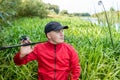 Portrait of a young fisherman in a thicket  of reeds with a spinning rod Royalty Free Stock Photo
