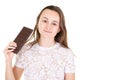 Portrait of young fit healthy woman holding some chocolate thinking