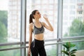 Portrait young fit woman drinking water during traning in the gym. Royalty Free Stock Photo