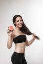 Portrait of young fit woman holding pink grapefruit Royalty Free Stock Photo