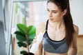 Portrait young fitness woman eating yogurt at home Royalty Free Stock Photo