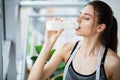 Portrait young fitness woman eating yogurt at home Royalty Free Stock Photo