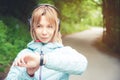 Portrait Young fitness woman looking at her smart watch while taking a break from sports training. Sportswoman checking Royalty Free Stock Photo