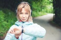 Portrait Young fitness woman looking at her smart watch while taking a break from sports training. Sportswoman checking Royalty Free Stock Photo