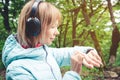 Portrait Young fitness woman looking at her smart watch while taking a break from sports training. Sportswoman checking Royalty Free Stock Photo