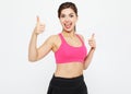 Portrait of a young fitness woman showing ok sign isolated on a white background Royalty Free Stock Photo