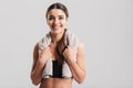 Portrait of young fitness woman in sportswear posing with towel Royalty Free Stock Photo