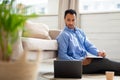 Portrait of young Arab man using laptop and writing Royalty Free Stock Photo