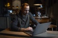 Portrait of young freelancer, man who using laptop in cafe