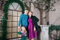 Portrait of young friendly family looking at camera on Christmas morning. Father, mother and daughter