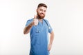 Portrait of a young friendly man doctor with stethoscope showing Royalty Free Stock Photo