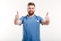 Portrait of a young friendly man doctor with stethoscope showing Royalty Free Stock Photo