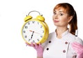 Portrait of young friendly woman doctor or nurse in white medical gown and gloves holding syringe and alarm clock in hands Royalty Free Stock Photo