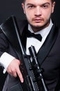 Portrait of young gangster holding armed rifle Royalty Free Stock Photo