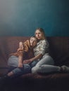 Portrait of young gay couple, girls lesbian sitting and hugging on background of blue wall. Concept of love, gay marriage and prid Royalty Free Stock Photo