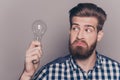 Portrait of young genious man with idea holding lamp