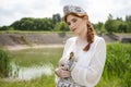 Portrait of Young Gentle caucasian Girl Posing Holding Duckling in Russian Style Dress and  Kokoshnik Outdoors Royalty Free Stock Photo