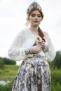 Portrait of Young Gentle caucasian Girl Posing Holding Duckling in Russian Style Dress and  Kokoshnik Outdoors Royalty Free Stock Photo