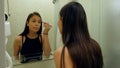 Portrait of young girl applying eyeshadow powder, prepearing for date Royalty Free Stock Photo