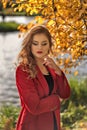 Portrait of a young girl with a beautiful make-up on closed eyes in an autumn landscape Royalty Free Stock Photo