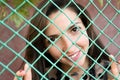 Portrait of a young girl behind a green net Royalty Free Stock Photo
