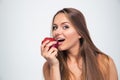 Portrait of a young girl biting apple Royalty Free Stock Photo