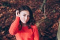 Portrait of young girl with blue eyes in the autumn forest