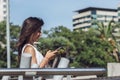 Portrait of young girl chatting on her smartphone over modern city background Royalty Free Stock Photo