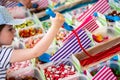 Portrait of young girl choosing sweets for gift in candies shop