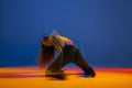 Portrait of young girl dancing heels dance over blue background in neon with mixed lights. Expressive hobby. Concept of Royalty Free Stock Photo