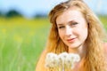 Portrait of a young girl with dandelions in her hands Royalty Free Stock Photo