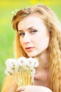 Portrait of a young girl with dandelions in her hands Royalty Free Stock Photo