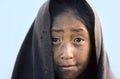 Portrait of young girl in early morning in local clothes looking sad