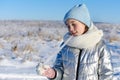 Portrait of young girl eating icicle on sunny winter day Royalty Free Stock Photo