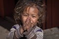 Portrait young girl with folded hands in street, Nepal. Close up