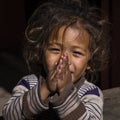 Portrait young girl with folded hands in street, Nepal. Close up