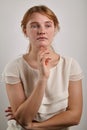 Portrait of young girl with ginger hair dressed in casual white blouse Royalty Free Stock Photo