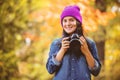 Girl in hat with professional camera on fall season park Royalty Free Stock Photo