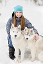 Portrait of a young girl with a husky puppies