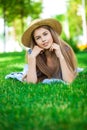 Portrait of a young girl lying on green grass Royalty Free Stock Photo