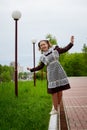 Portrait of a young girl in an old school uniform of the USSR with a black dress and a white apron. Teenager in the Park among