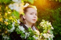 Portrait of a young girl in an old school uniform of the USSR with a black dress and a white apron. Teenager in the Park among the