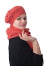 Portrait of a young girl in an openwork orange beret and handmade scarf on a white background Royalty Free Stock Photo