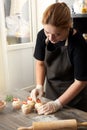 Portrait of a young girl pastry chef, in the kitchen