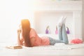 Portrait of young girl reading book lying on floor in living room Royalty Free Stock Photo