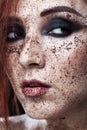 Portrait of young girl with red hair and ground coffee on the face. Photo with art makeup. Mature woman making cosmetic mask. Royalty Free Stock Photo