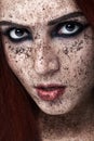 Portrait of young girl with red hair and ground coffee on the face. Photo with art makeup. Mature woman making cosmetic mask. Face Royalty Free Stock Photo