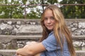 Portrait of young girl sitting on the stone steps at the old city Park. Walk. Royalty Free Stock Photo