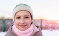 Portrait of a young girl smiling in winter at sunset. wearing warm winter close, red sunset, winter time sports Royalty Free Stock Photo